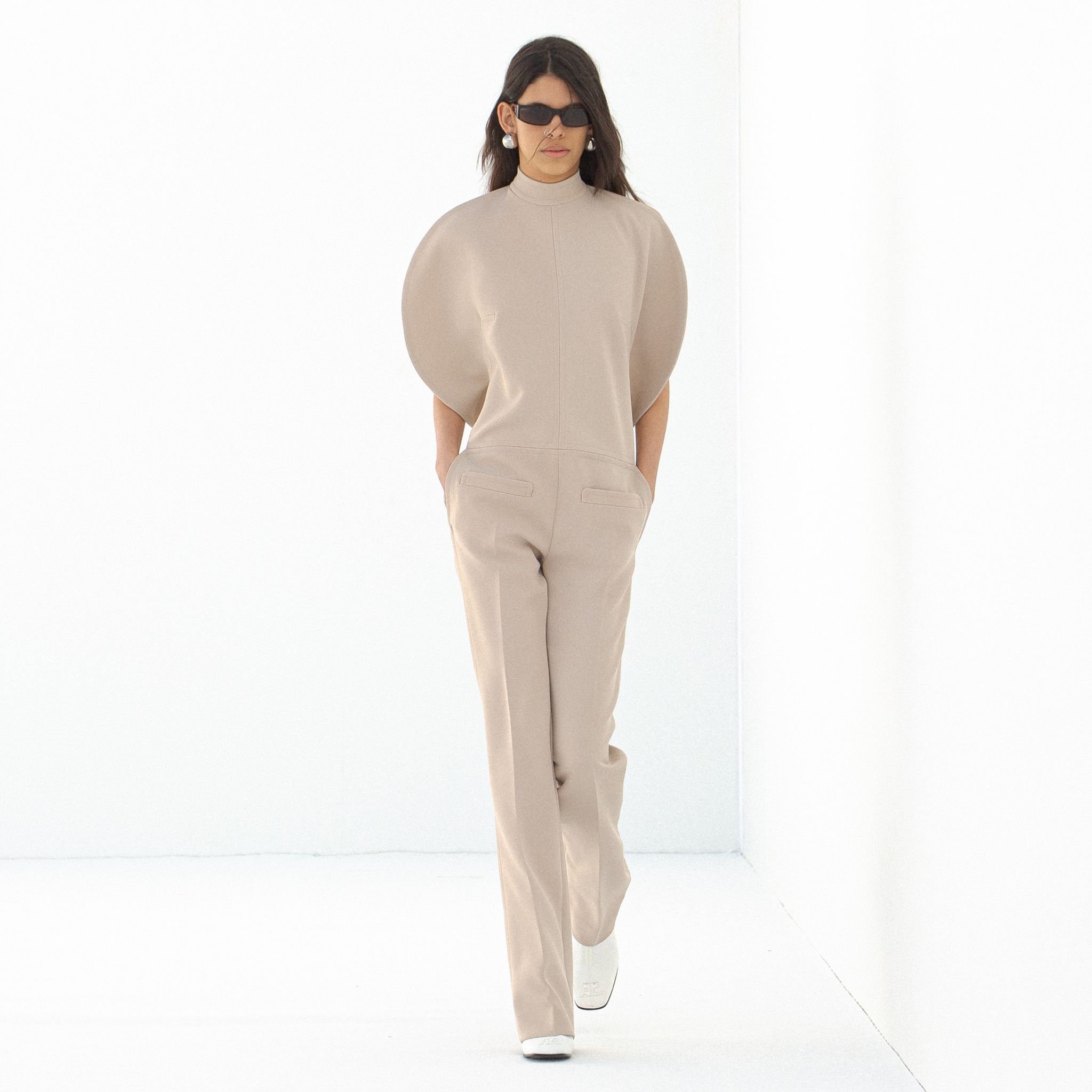 Elegant beige outfit with puffed sleeves, perfect for Courrèges fashion collection on an ecommerce site.