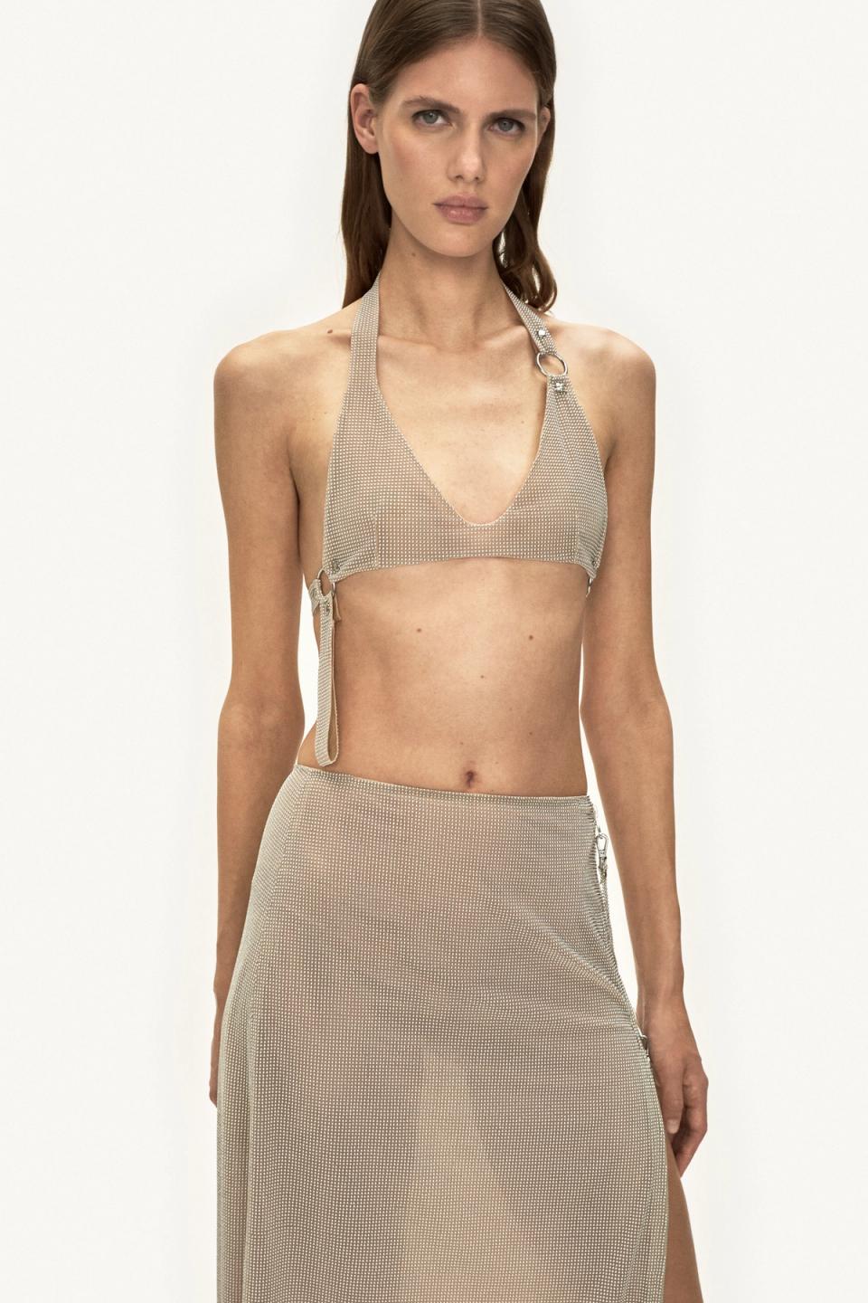 Elegant model wearing Courrèges mesh top and matching skirt, fashionable and chic outfit.