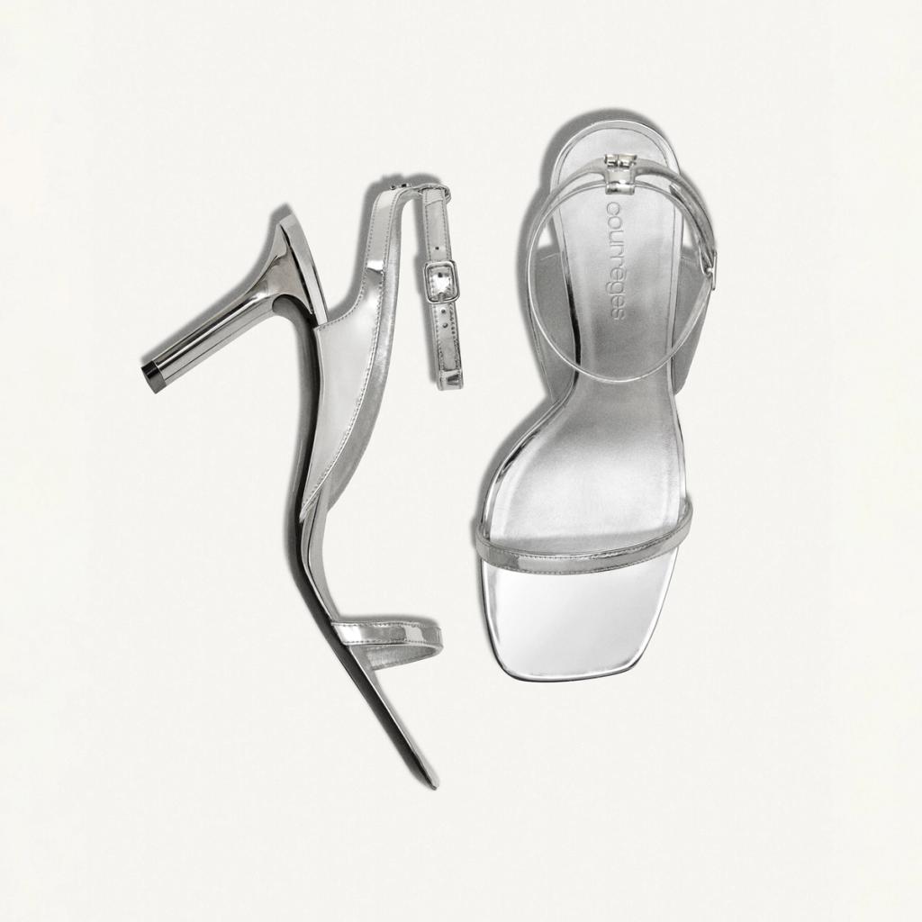 Elegant silver high-heeled sandals with ankle straps, stylishly designed for Courrèges fashion.