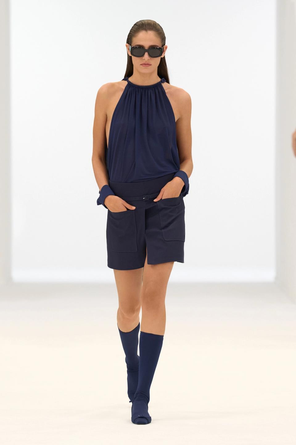 Elegant blue sleeveless top with matching shorts, styled for Courrèges fashion showcase.