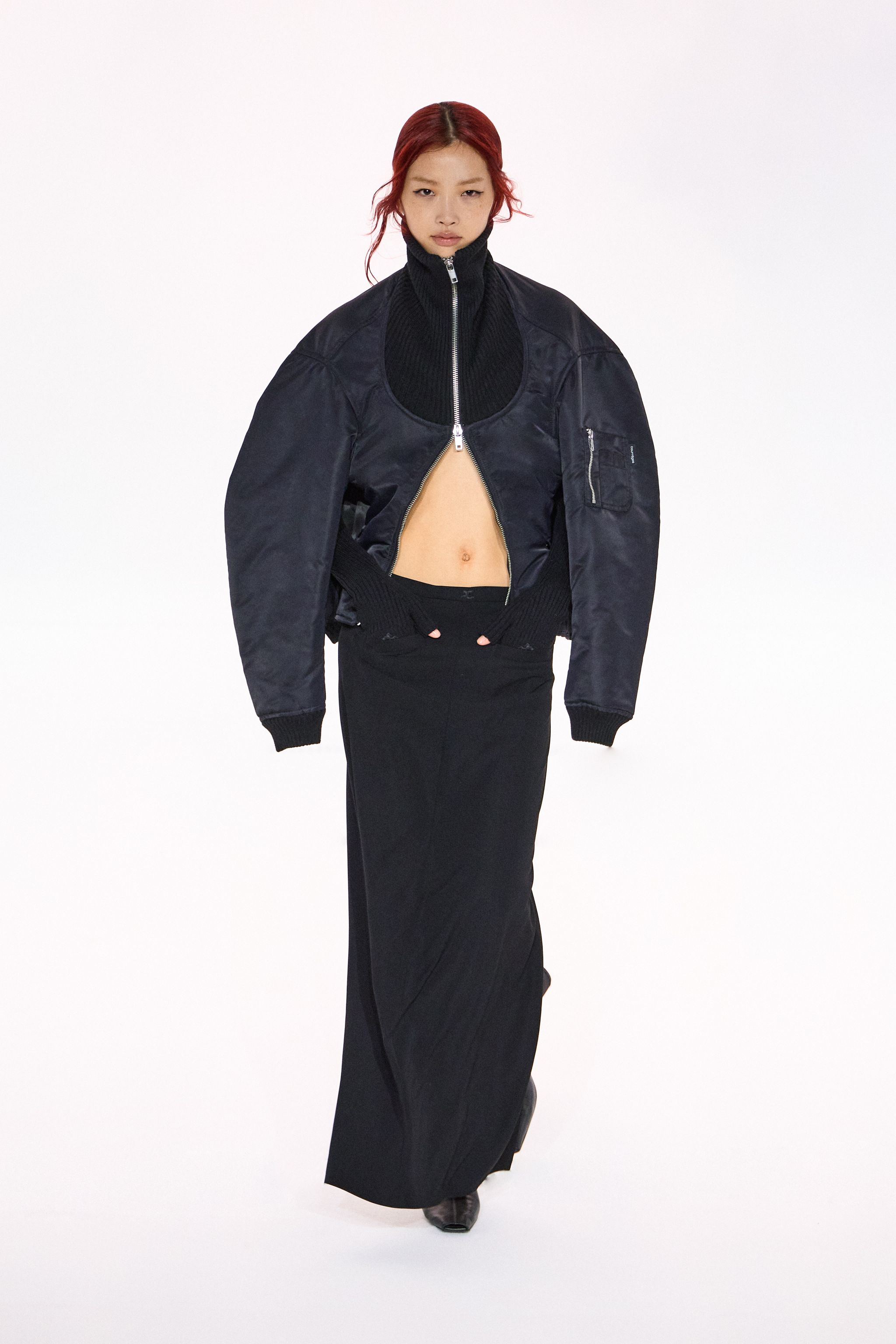 Elegant black bomber jacket and long skirt from Courrèges for a chic, modern look.