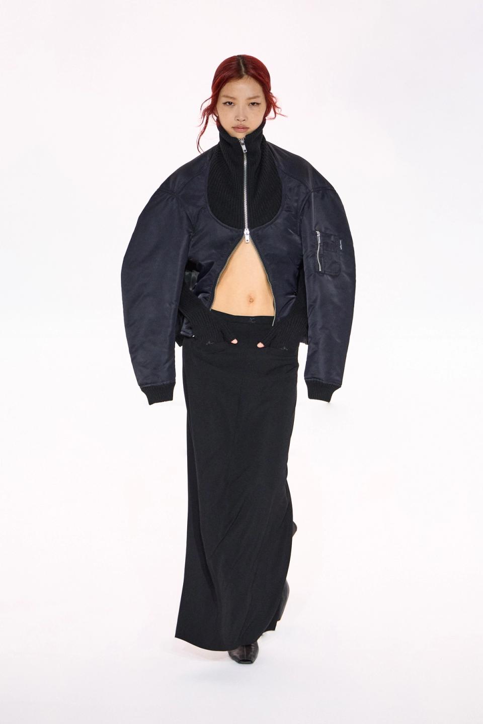 Elegant black bomber jacket and long skirt from Courrèges for a chic, modern look.
