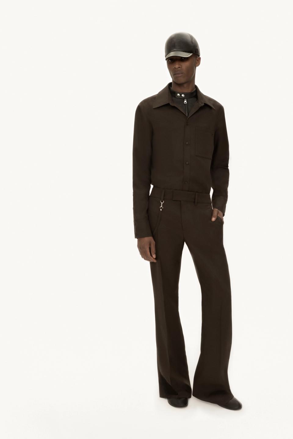 Elegant black fashion outfit with tailored trousers and jacket, perfect for Courrèges collection.