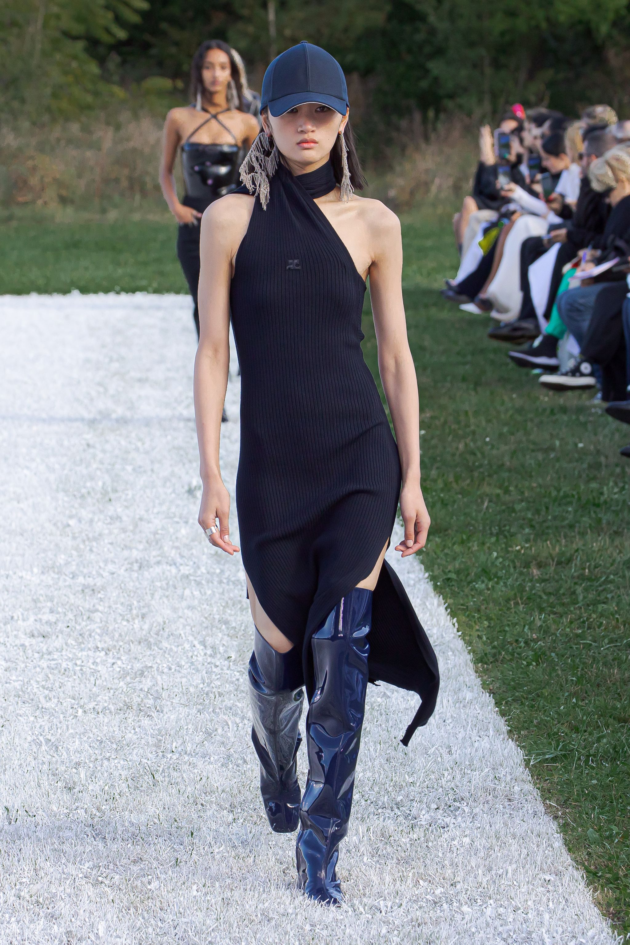 Elegant black dress with unique design, showcased at a Courrèges runway, perfect for fashion lovers.