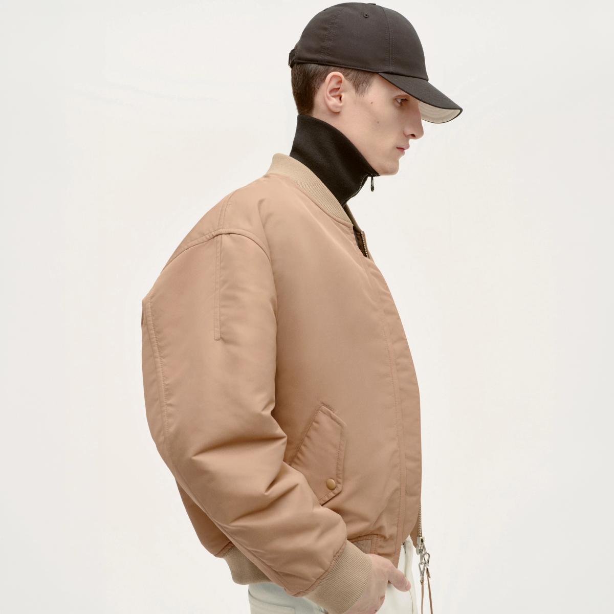 Elegant beige bomber jacket by Courrèges, featuring a sleek design for a modern look.