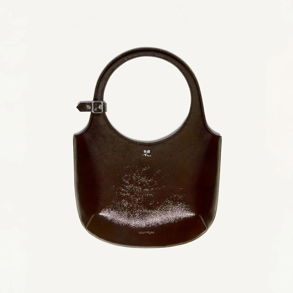 Elegant Courrèges handbag with a sleek design, featuring a shiny finish and modern style.