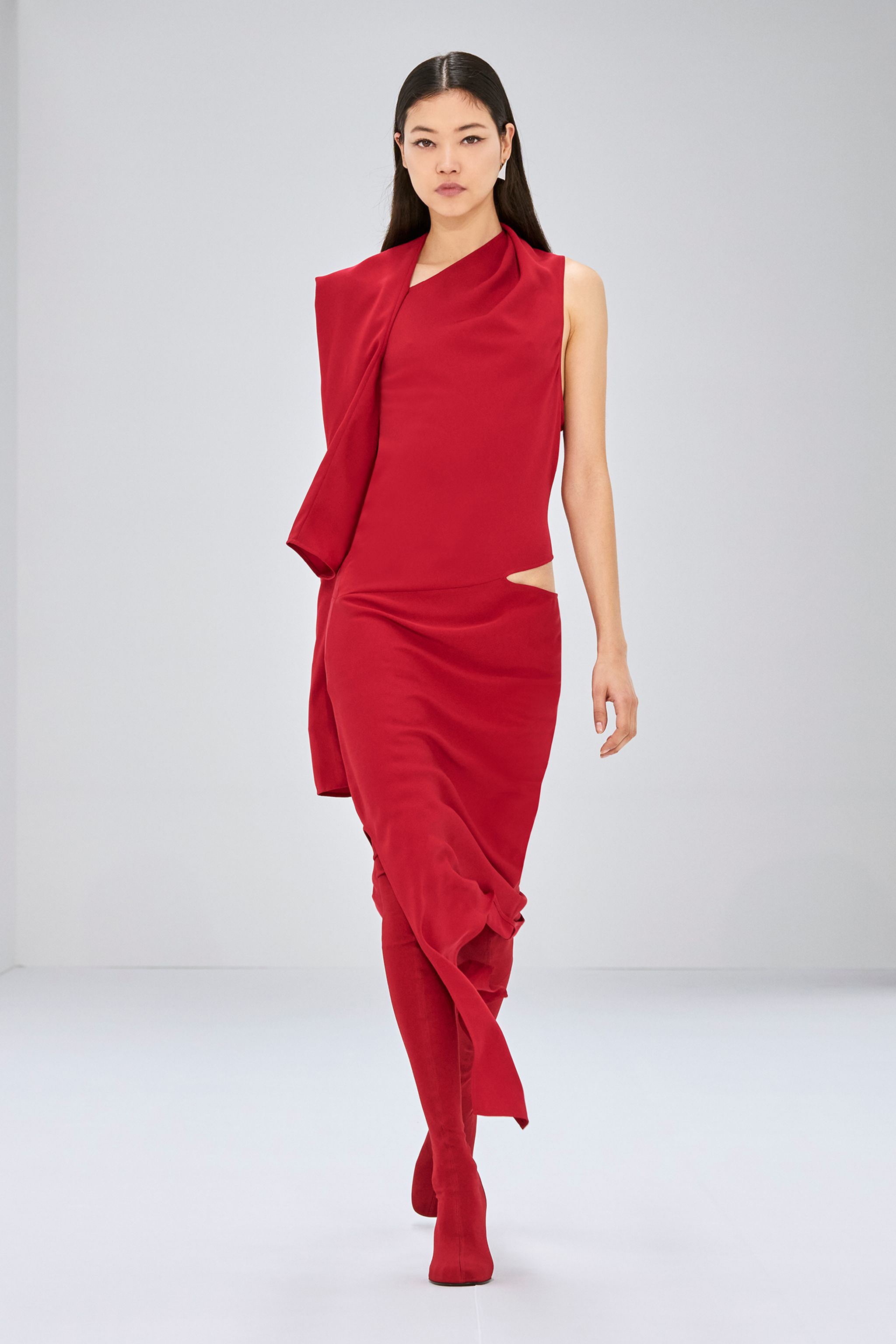 Elegant red dress with cut-outs and asymmetric draped details for Courrèges fashion.