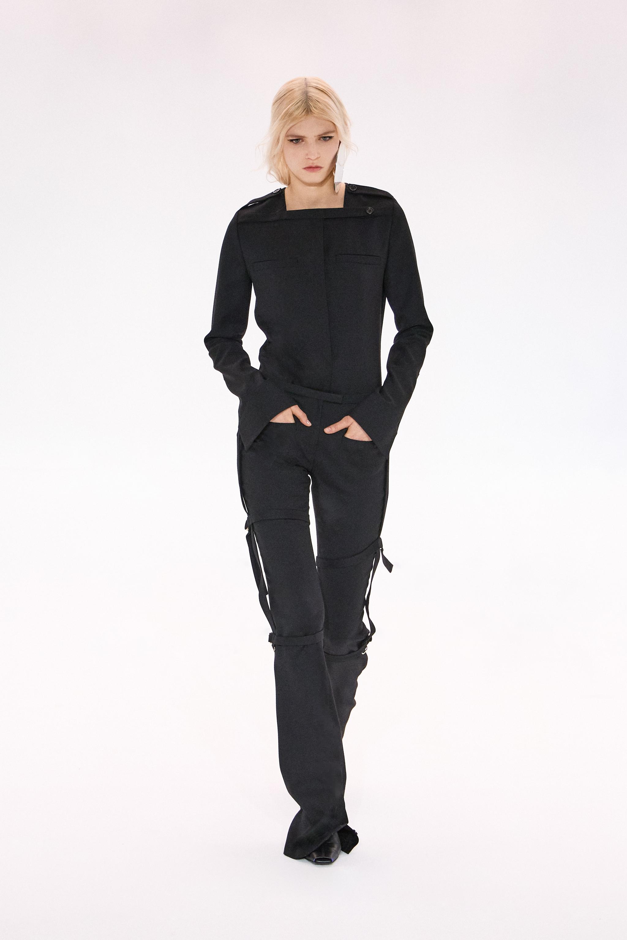 Elegant black Courrèges fashion outfit featuring a tailored jacket and stylish cargo pants.