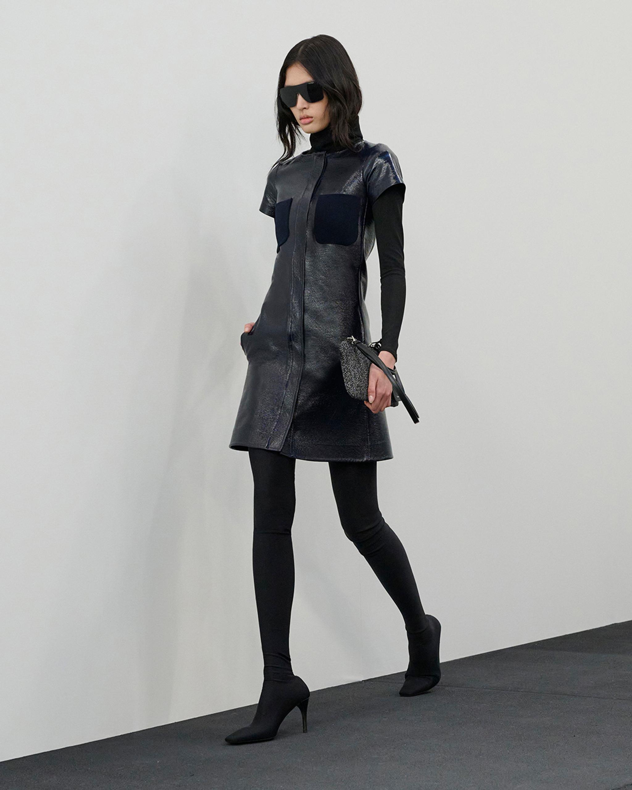 Elegant black leather dress with unique design details, perfect for Courrèges fashion.