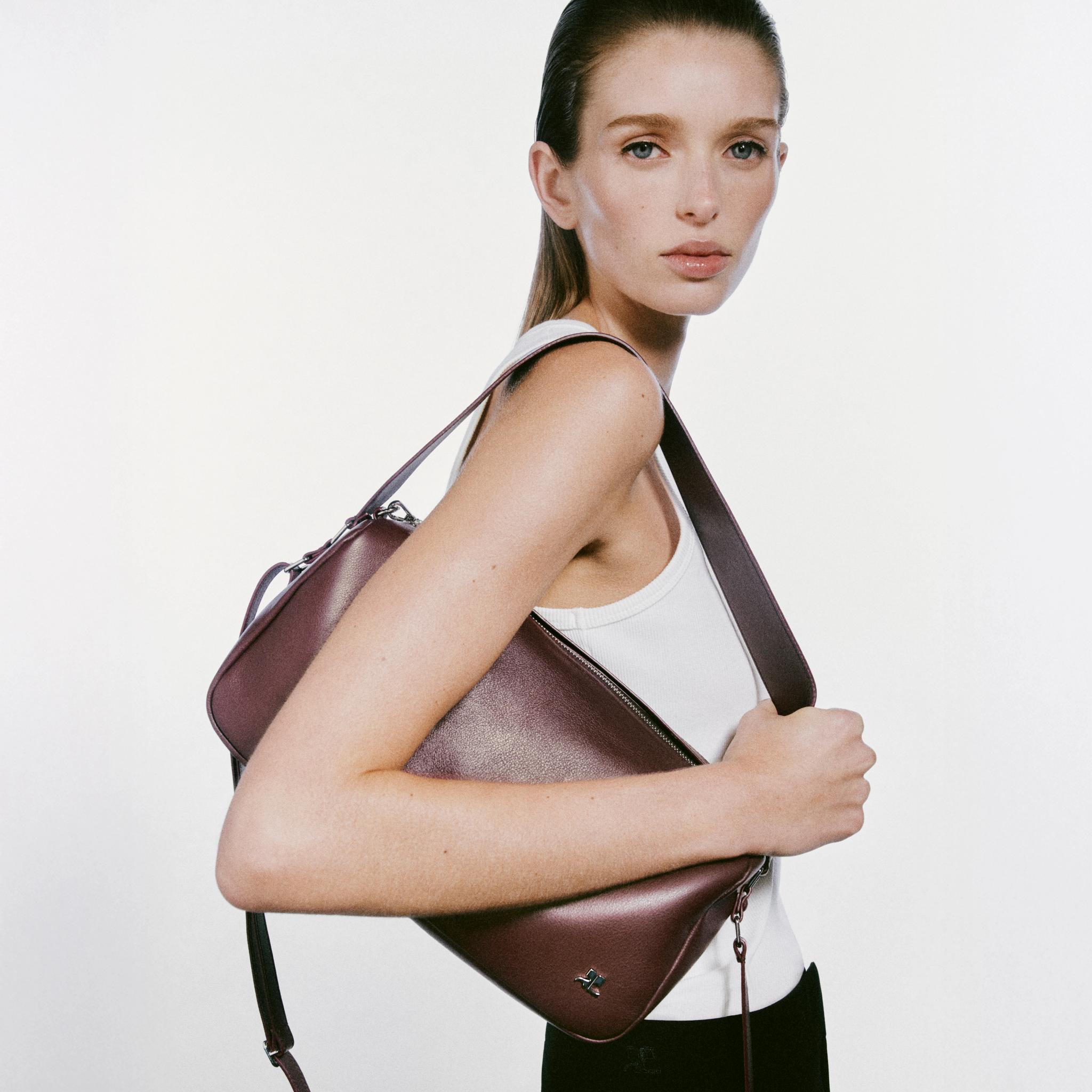 Elegant model showcasing a stylish Courrèges handbag for a modern fashion look.