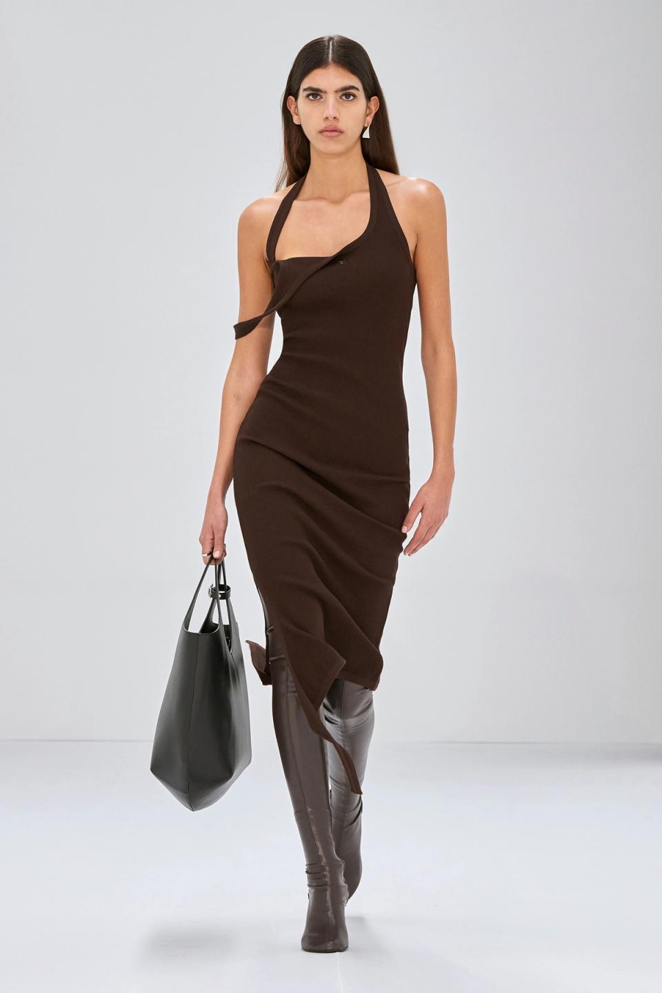 Elegant model wearing Courrèges brown dress with asymmetrical design for a fashion statement.
