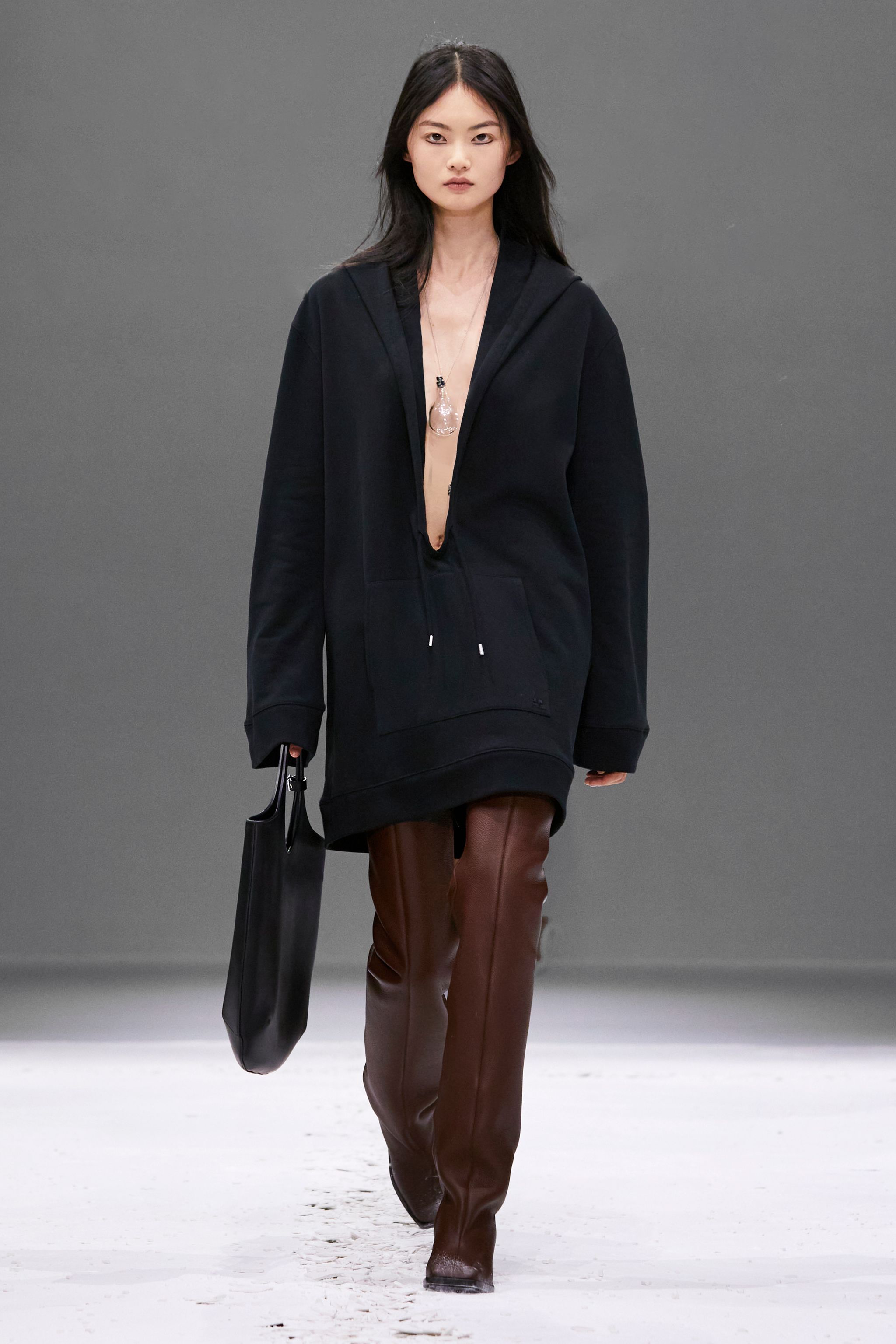 Elegant black oversized hoodie with a deep neckline, styled for Courrèges' modern fashion look.