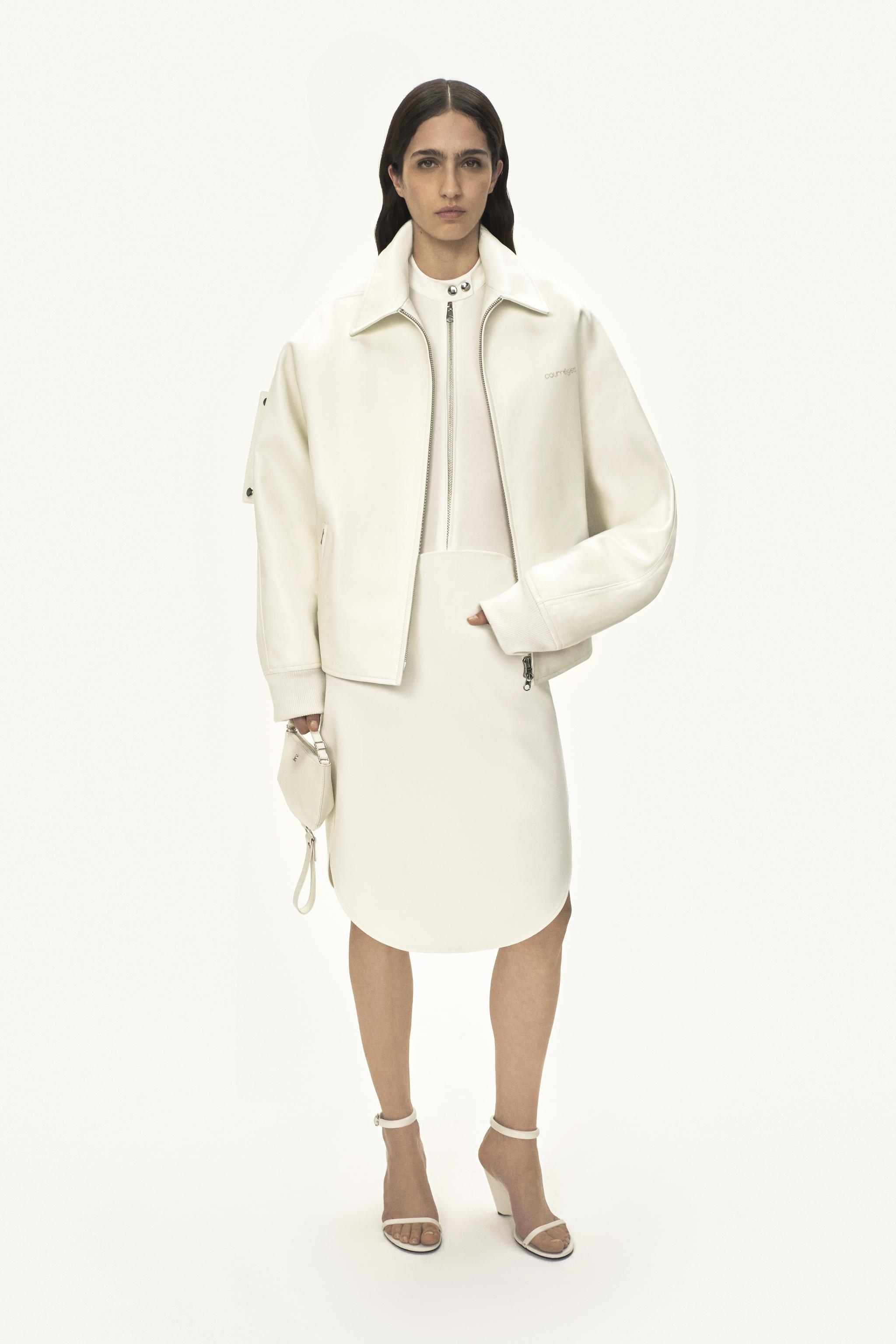 Tenue blanche élégante de Courrèges avec veste tendance et jupe assortie, parfaite pour les amateurs de mode.
