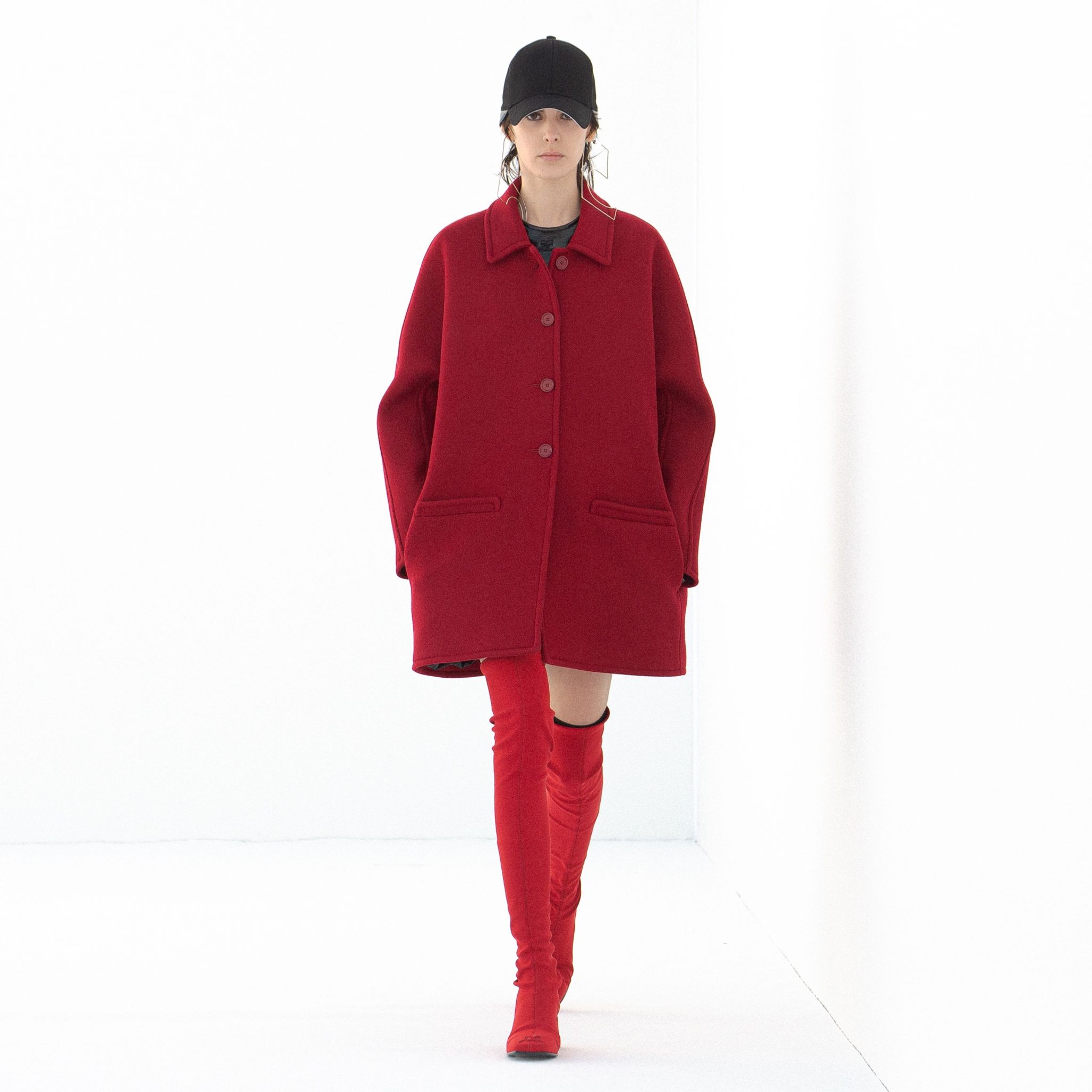 Elegant red coat with oversized fit, featuring classic collar and button closure, Courrèges style.