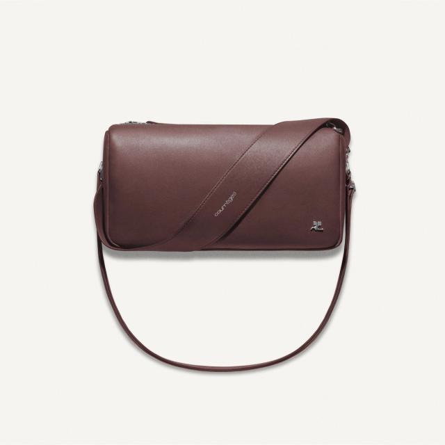 Elegant burgundy leather handbag with sleek design, featuring Courrèges branding for fashion.