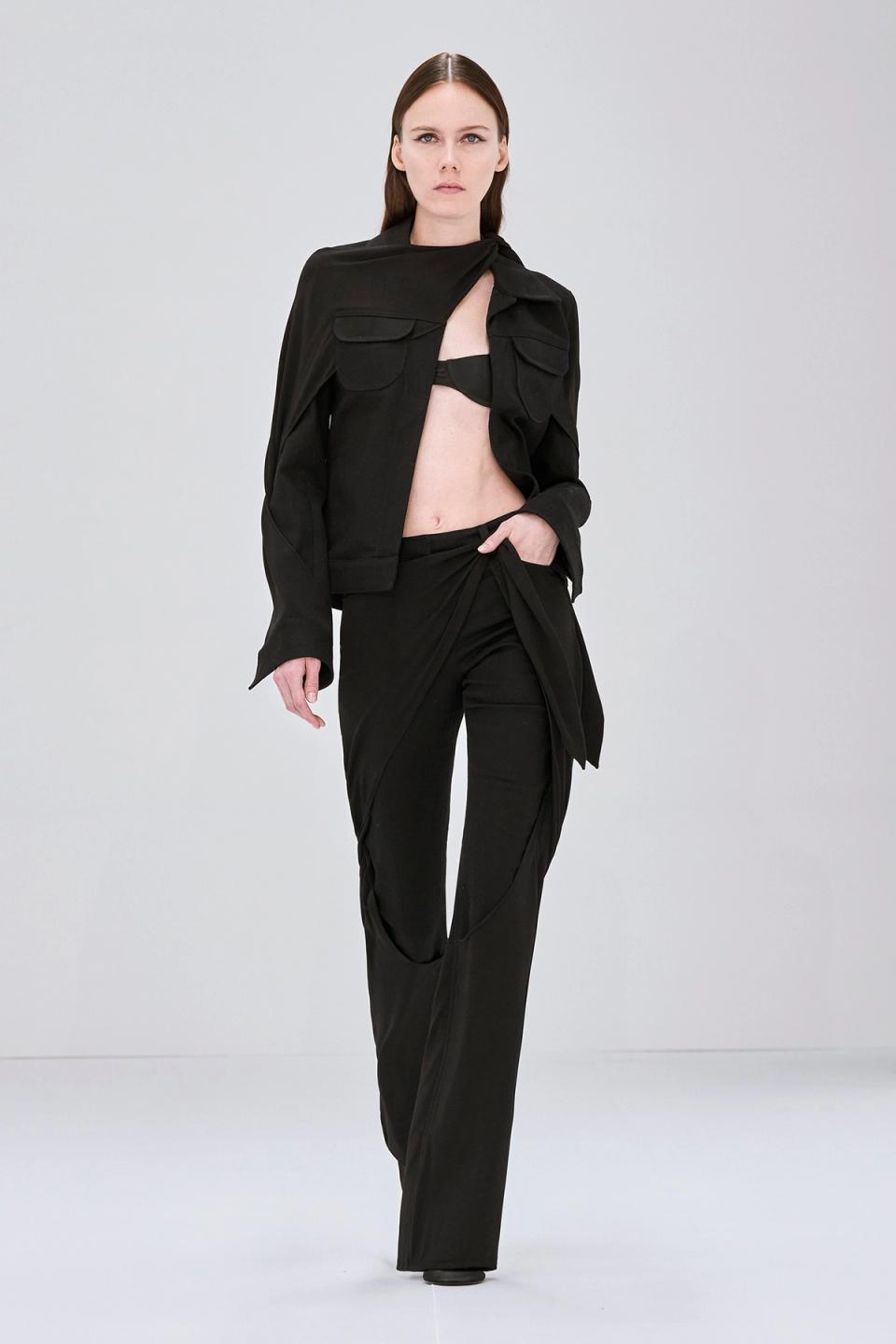 Elegant black fashion ensemble with a strapless top, long skirt, and futuristic sunglasses by Courrèges.