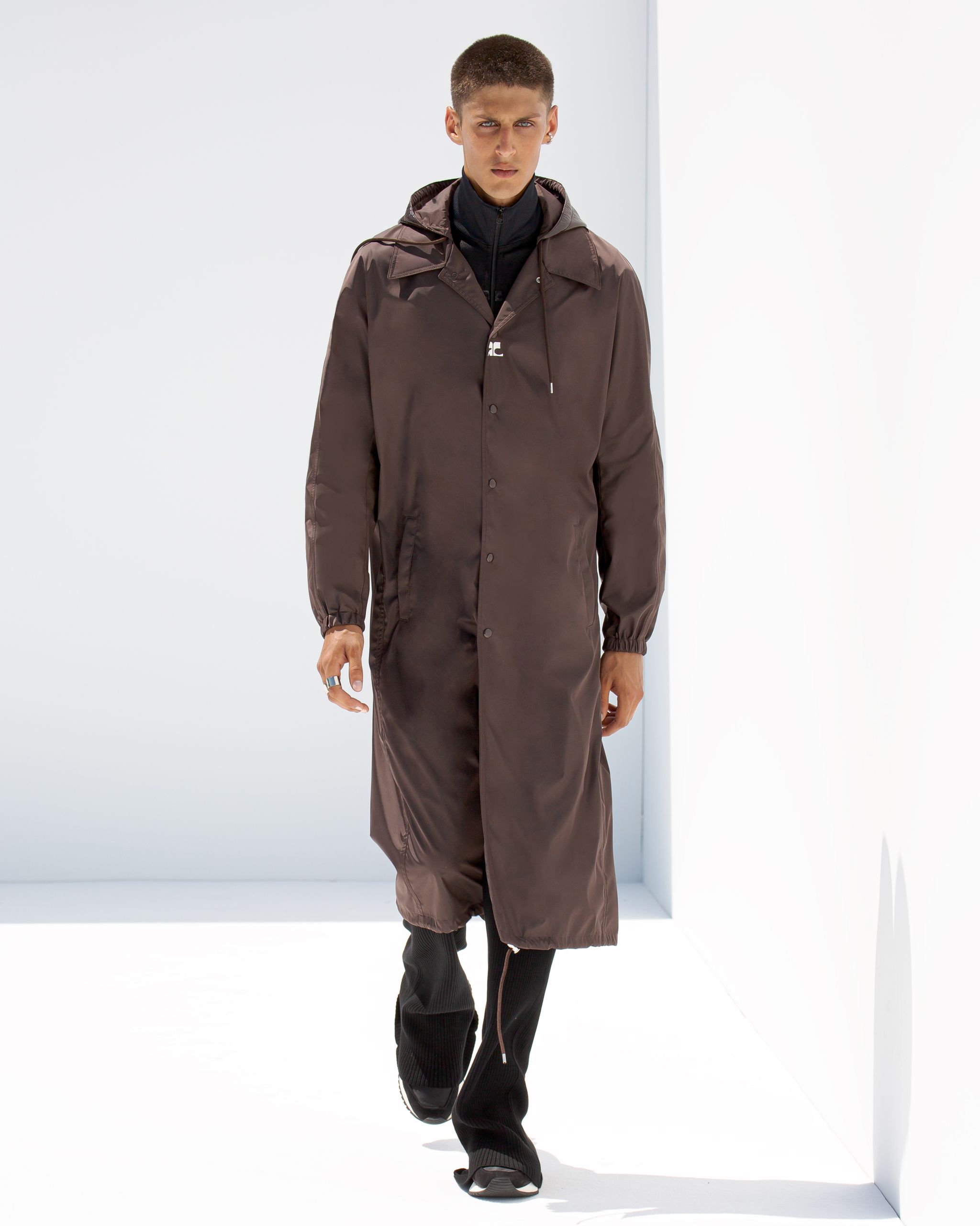 Elegant brown trench coat from Courrèges, perfect for modern fashion on an ecommerce site.