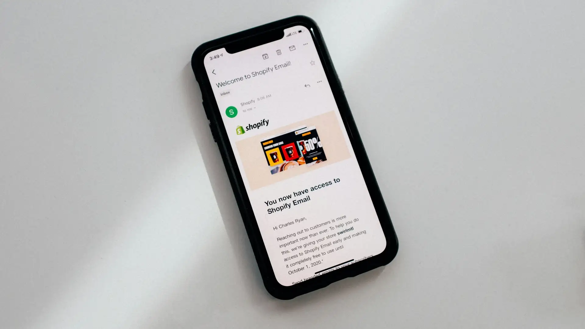 A cell phone is displaying an email from Shopify.