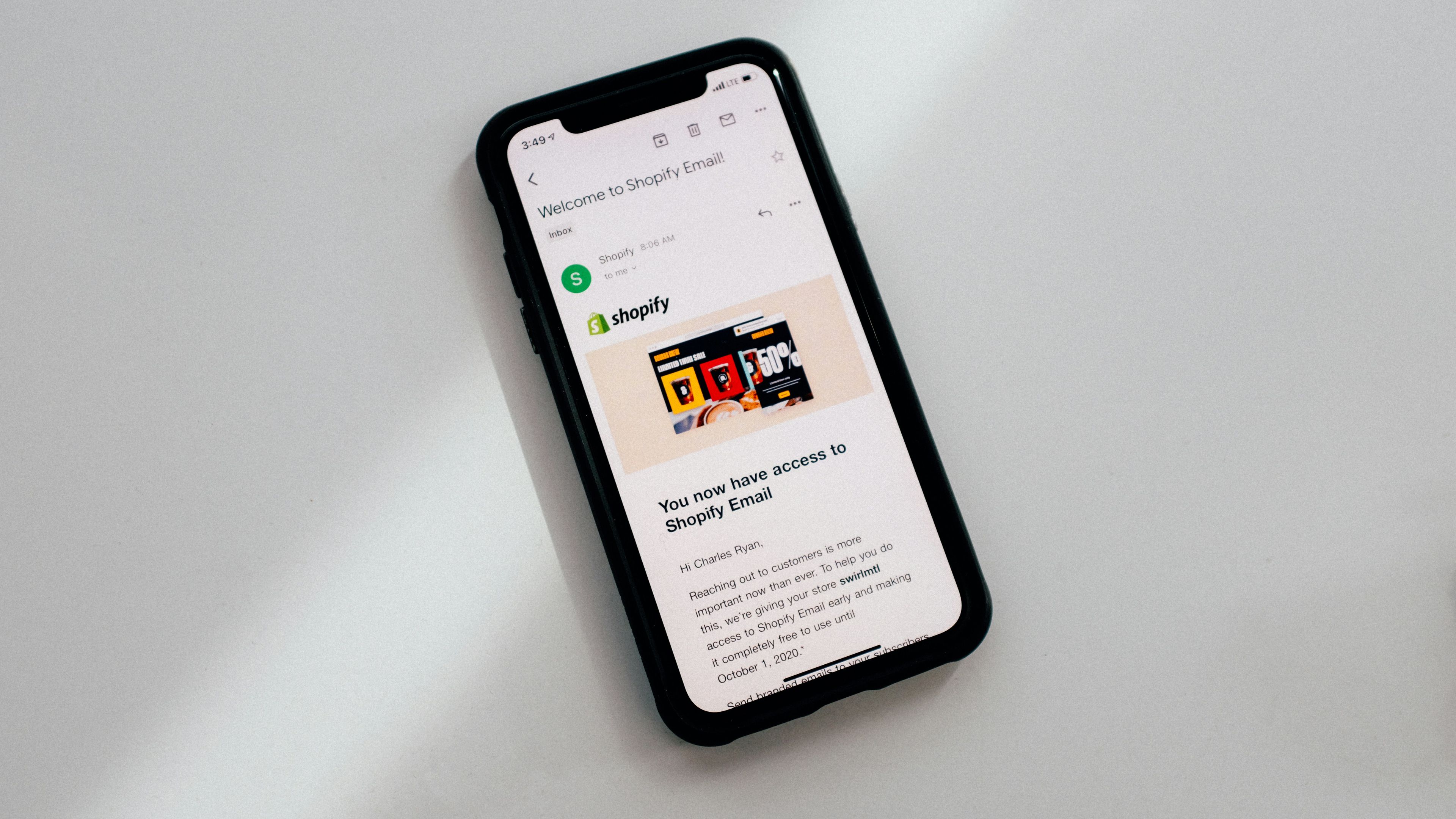 a cell phone is displaying an email from shopify .