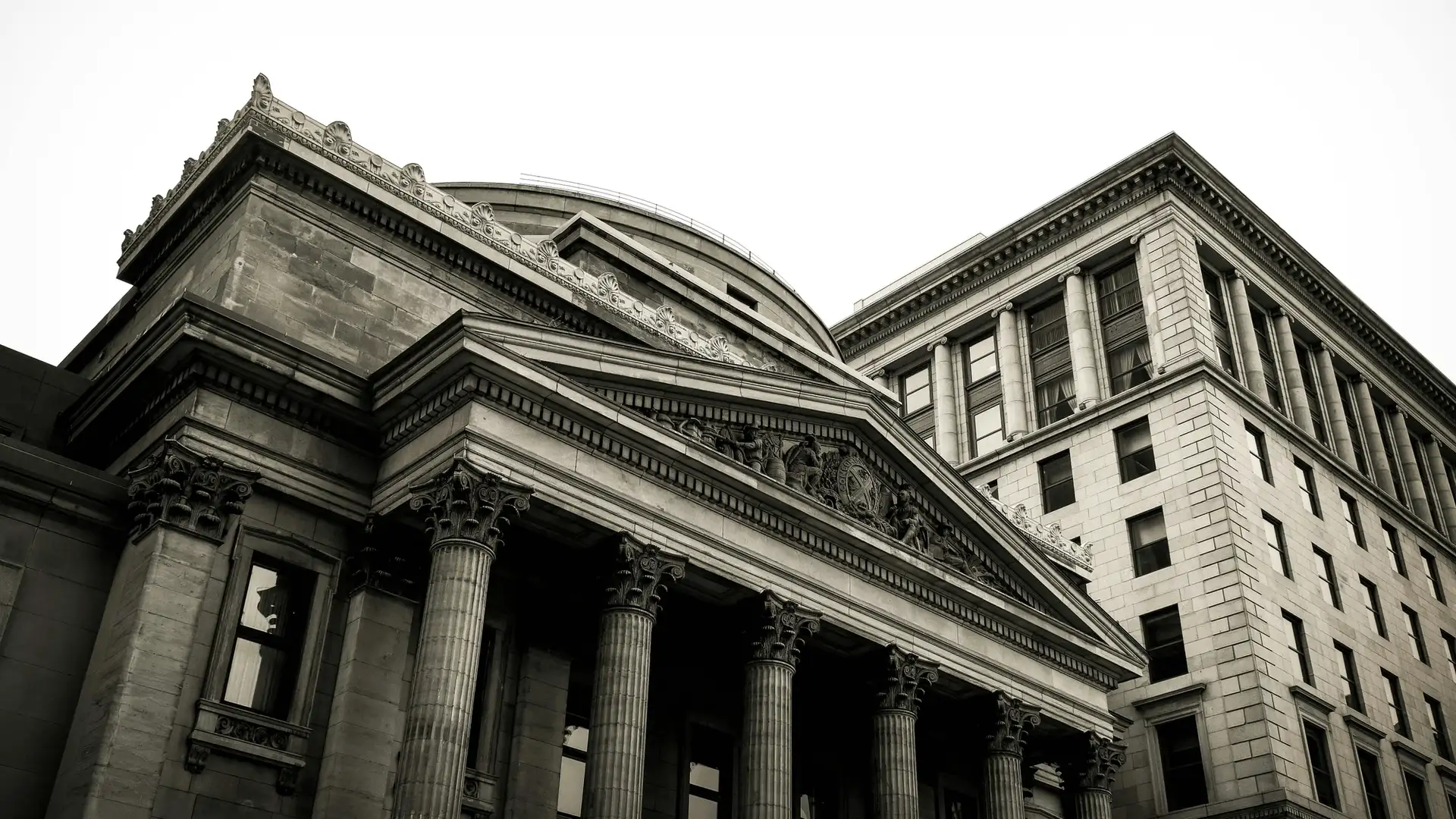 A black and white photo of a large building with columns.