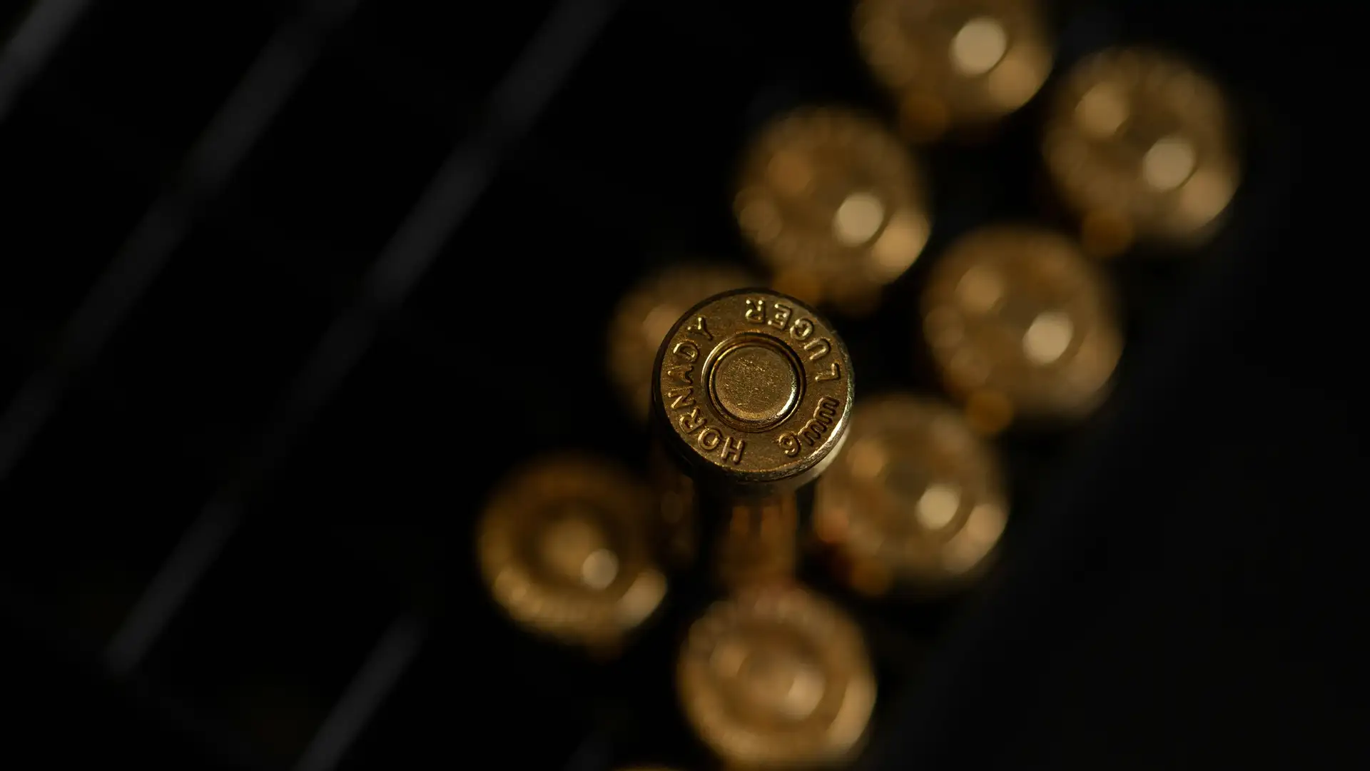 a close up of a bunch of gold bullets on a black surface .