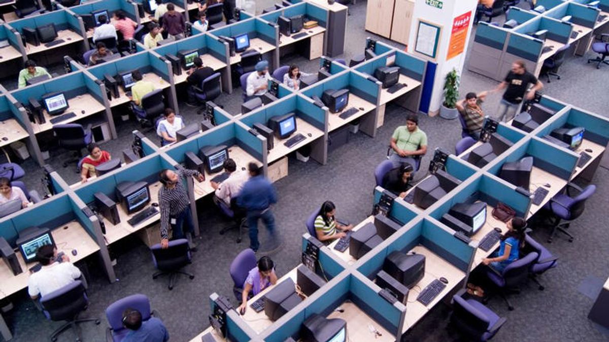 Workers at their cubicles.