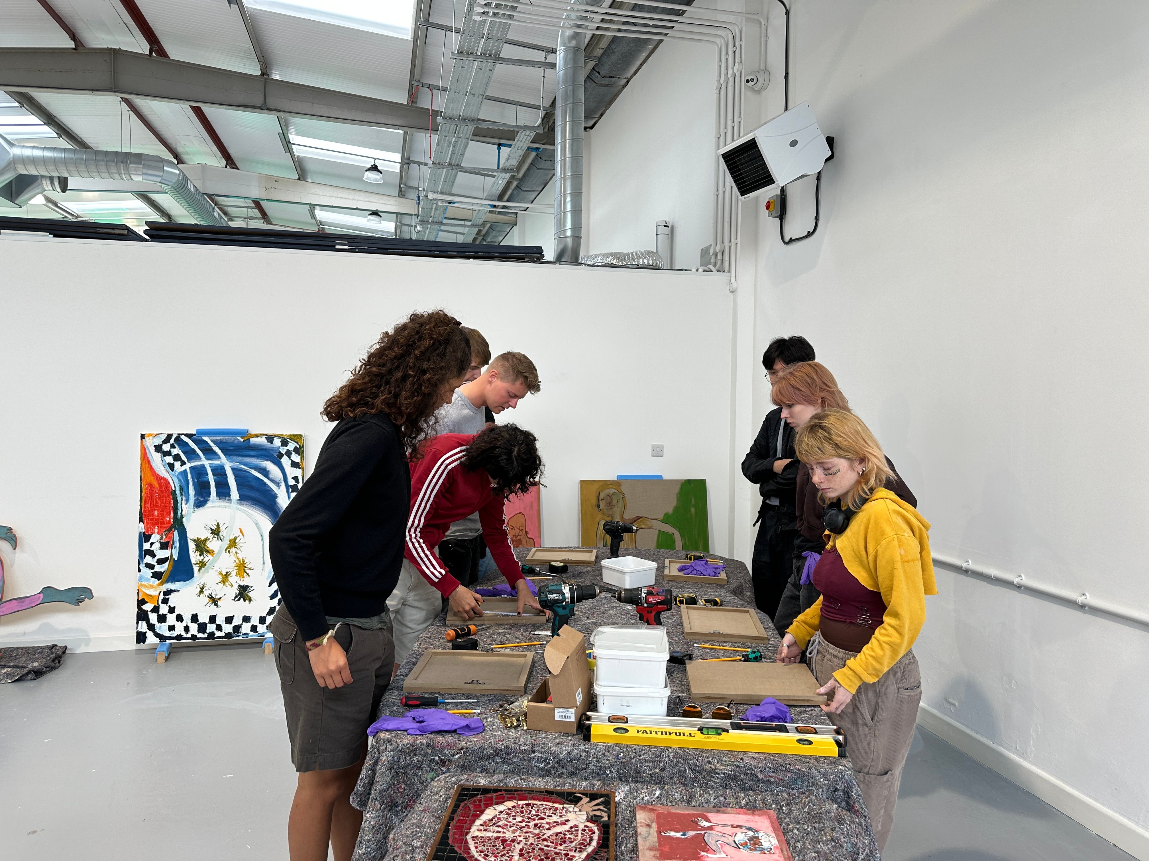 A group of people handling art works