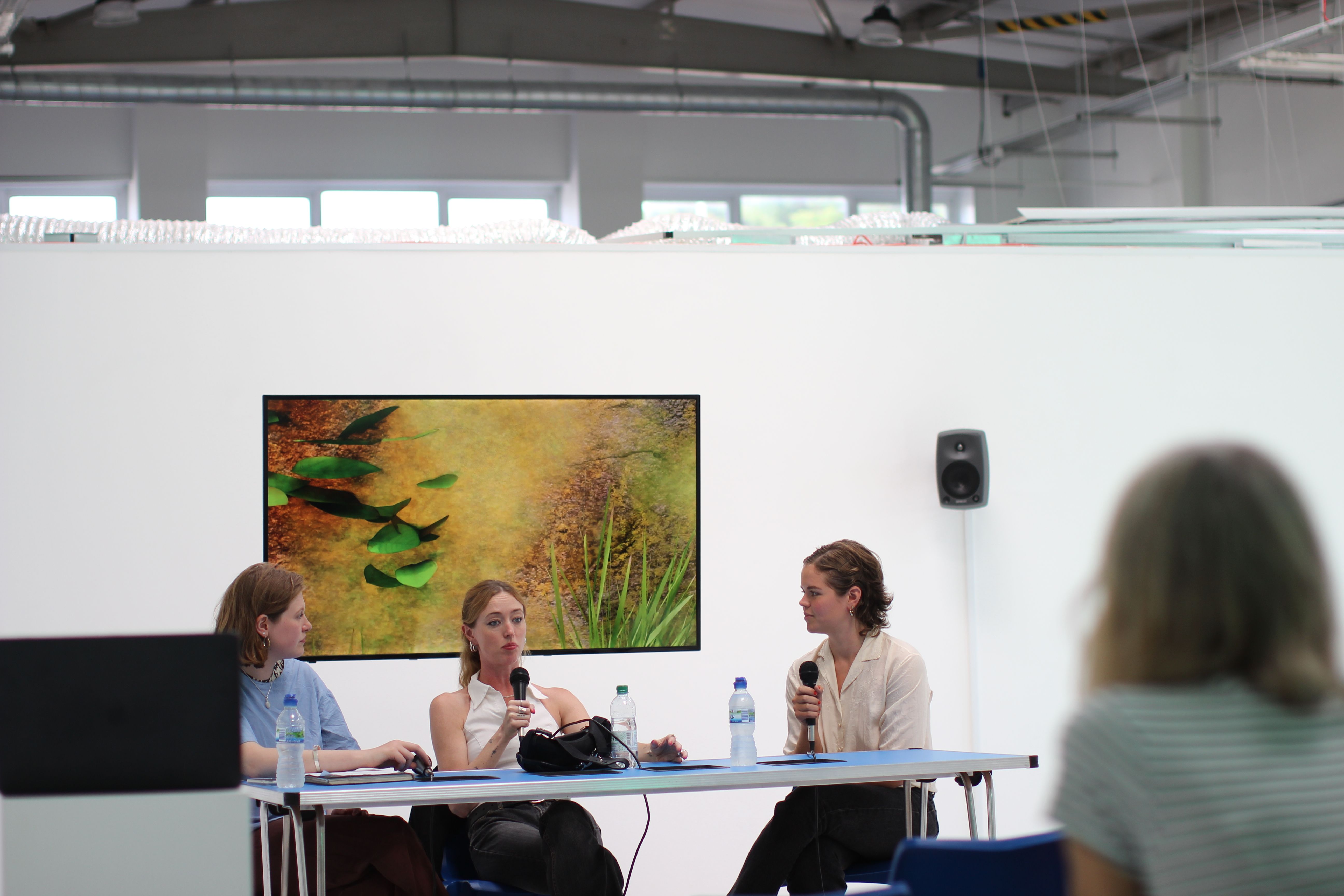 Three people speaking at a table 