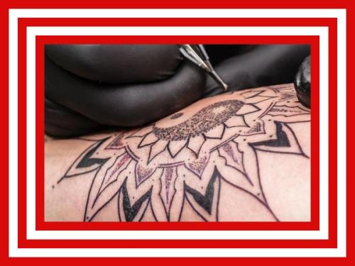 flower tattoo being applied to arm