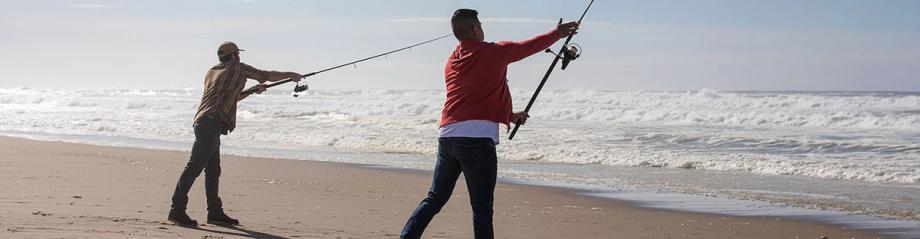 Two anglers casting surf fishing rods into the breaking waves at Horsfall Beach.