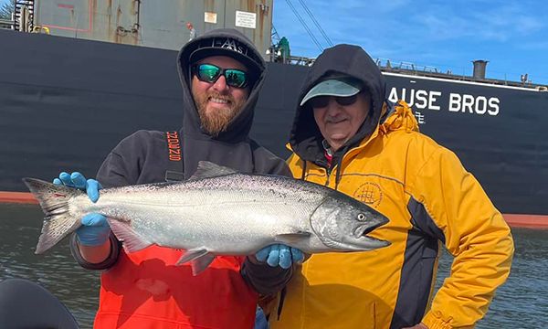 Fishermen holding a salmon