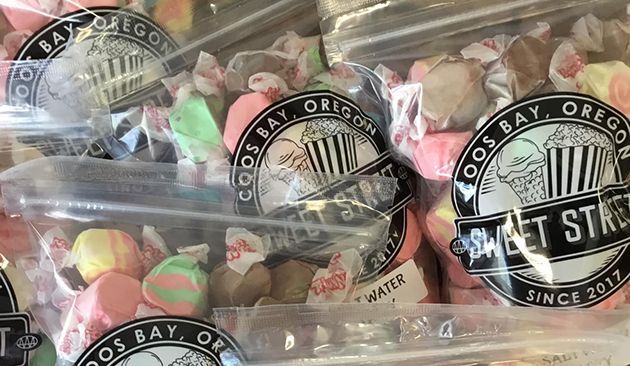Bags of colorful saltwater taffy labeled “Sweet Street” from Coos Bay, Oregon.
