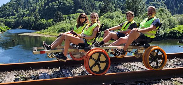 A family of four pedal the rails on the Coos Historic Railway.