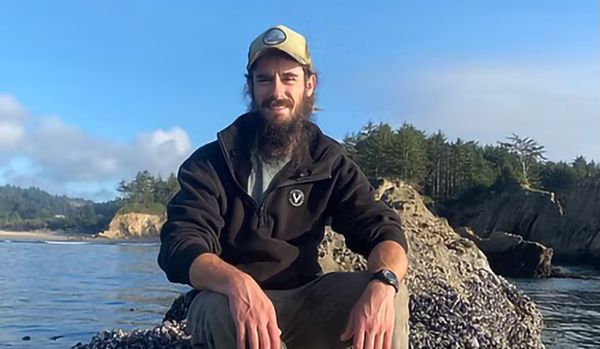 Guide Robbie McNulty sitting on a rock