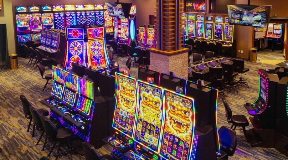 Rows of colorful slot machines light up the gaming floor at Three Rivers Casino in Coos Bay.