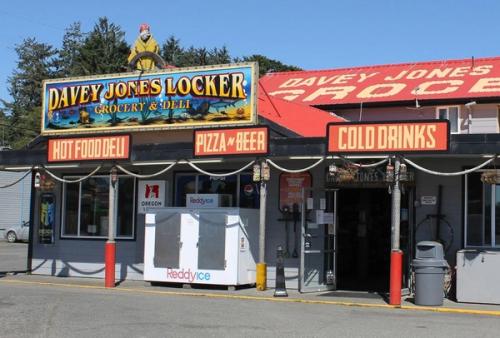 Davey Jones Locker Grocery & Deli storefront with a nautical sign and rope-wrapped porch posts.