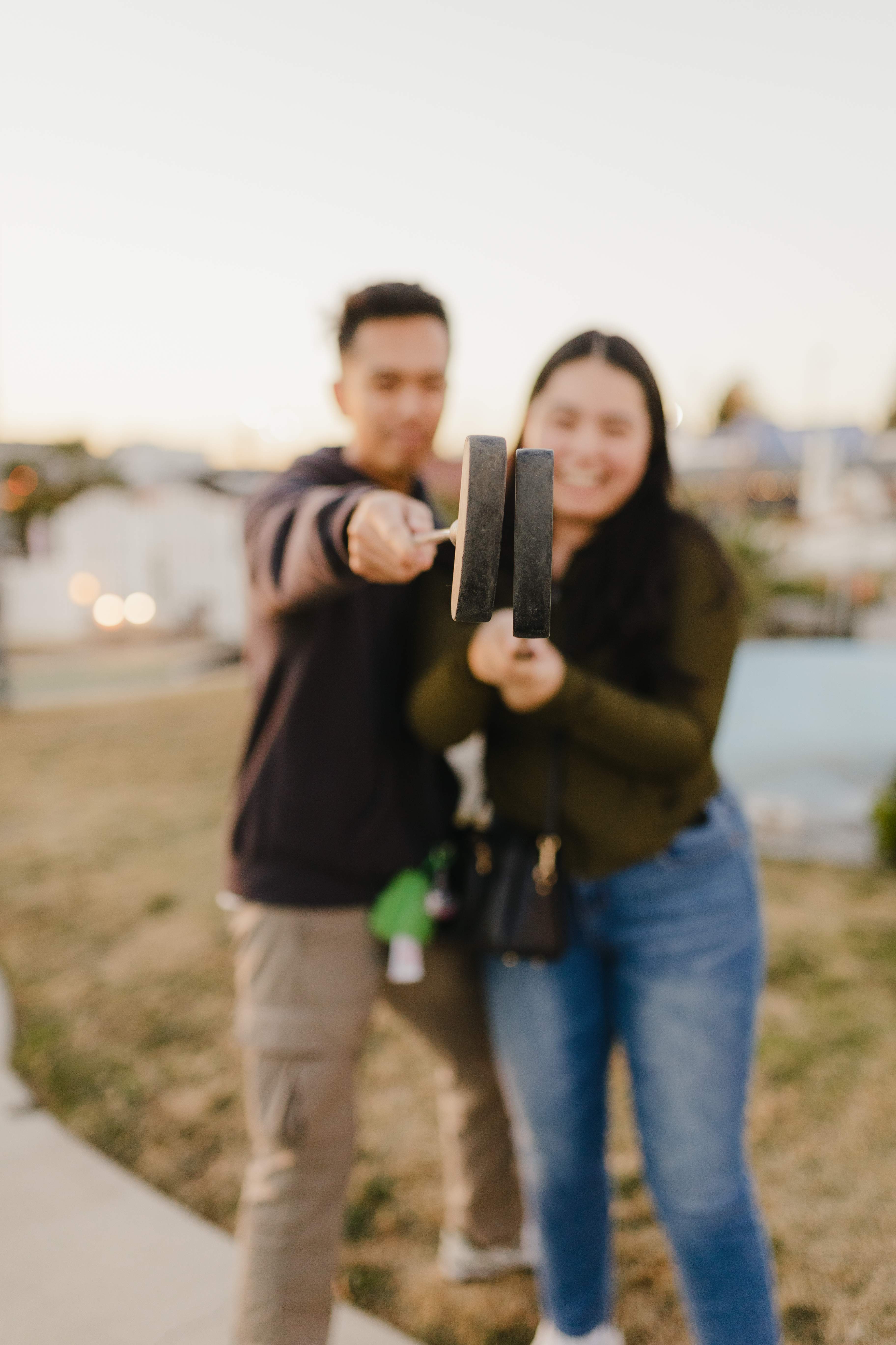 Couple holding miniature golf putters at Bullwinkle's Upland
