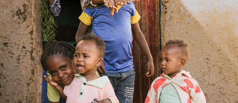 A group of children smiling outside a home in Oromia, Ethiopia