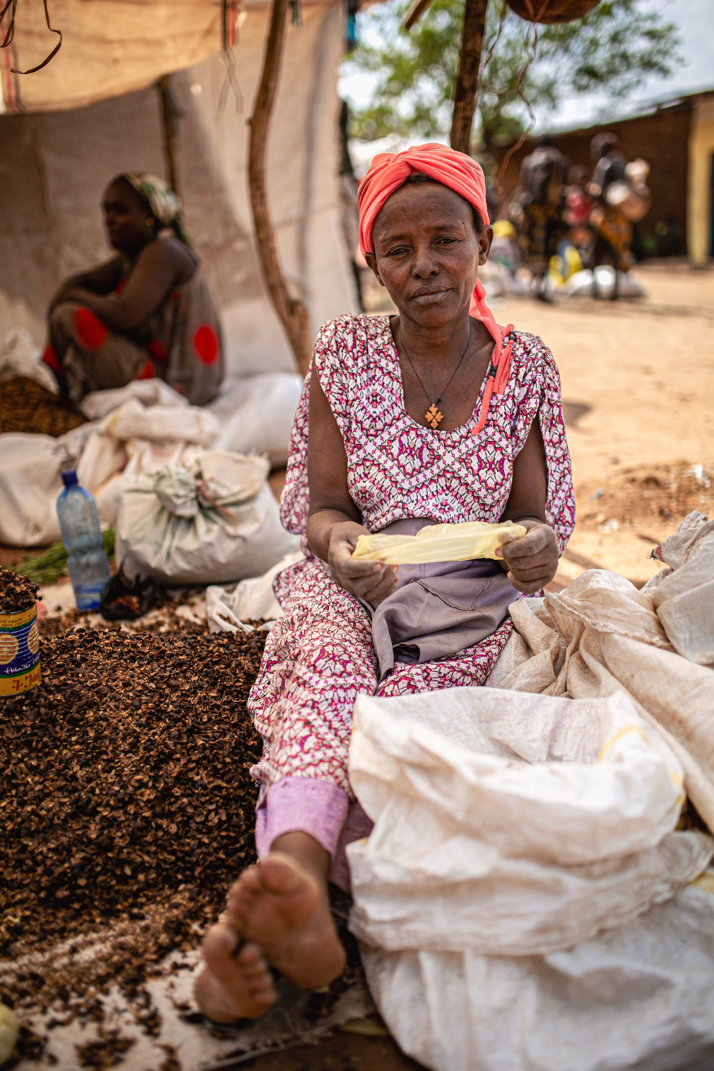 A woman sorting grain at a local market in Ethiopia