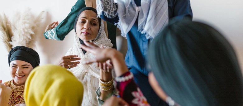 A group of women in colourful hijabs enjoying each other's company