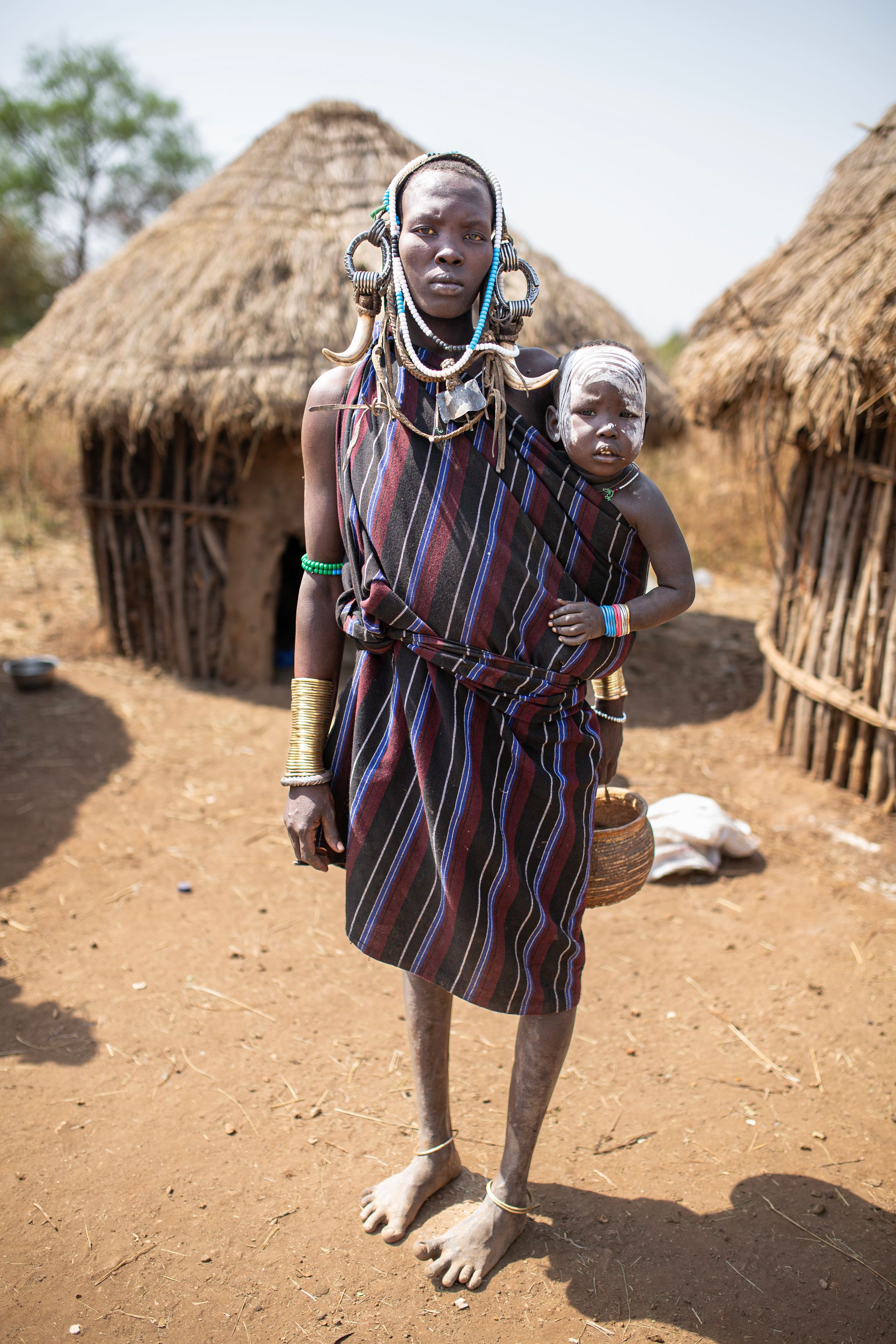 An Oromo mother and her child in traditional dress in a rural Ethiopian village