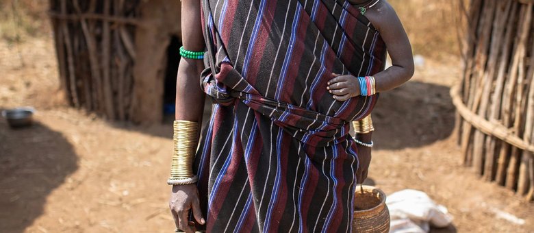 An Oromo mother and her child in traditional dress in a rural Ethiopian village