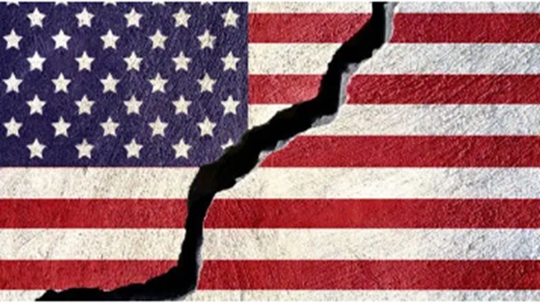 American flag with a large crack running through it, symbolising division and instability in the United States.
