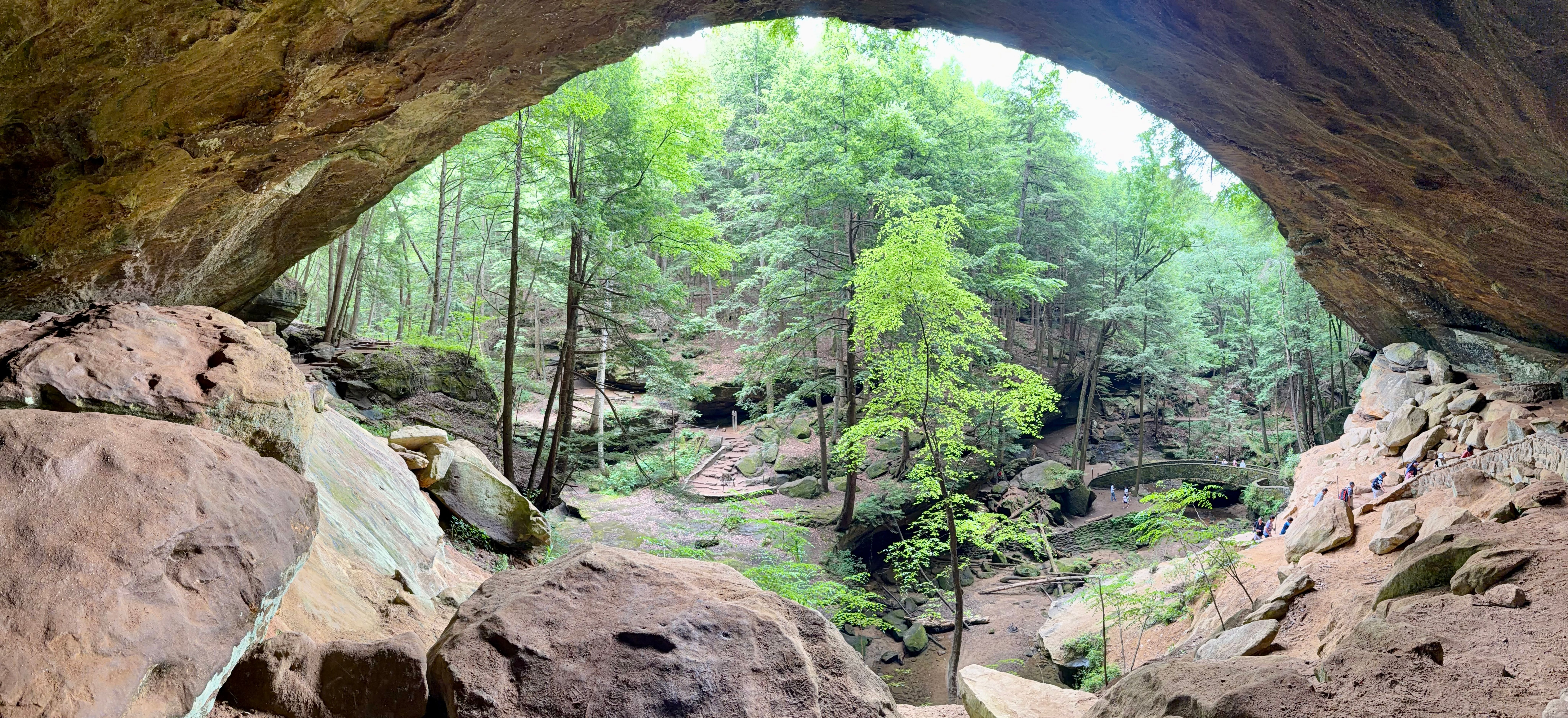 View from beneath the massive sandstone overhang at Old Man’s Cave overlooking the wooded gorge and hiking trail.