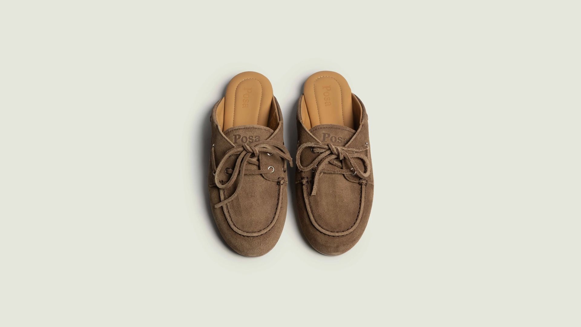 POSA Studio suede loafers shot from above on a cream background