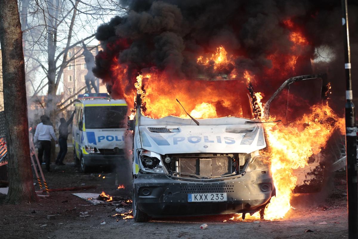 A Swedish police van on fire.