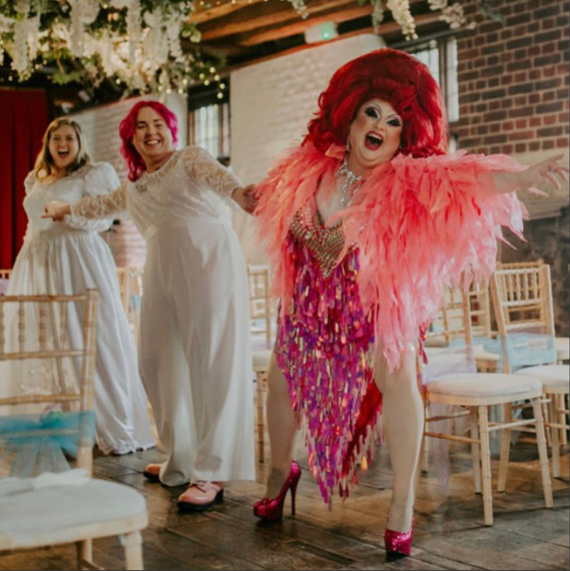Martin Fox, as drag alter ego Maria Hurtz, with a marrying couple