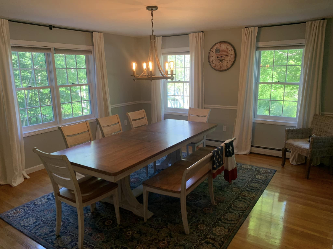 A warm-tone dining room painted by Brookstone Painting and Carpentry in Plymouth County and Cape Cod