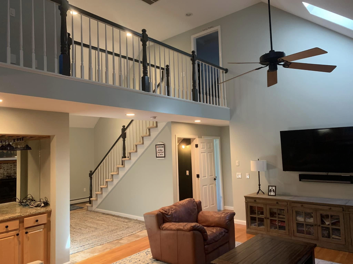 Interior painting of a Plymouth County living room with a vaulted ceiling by Brookstone Painting and Carpentry