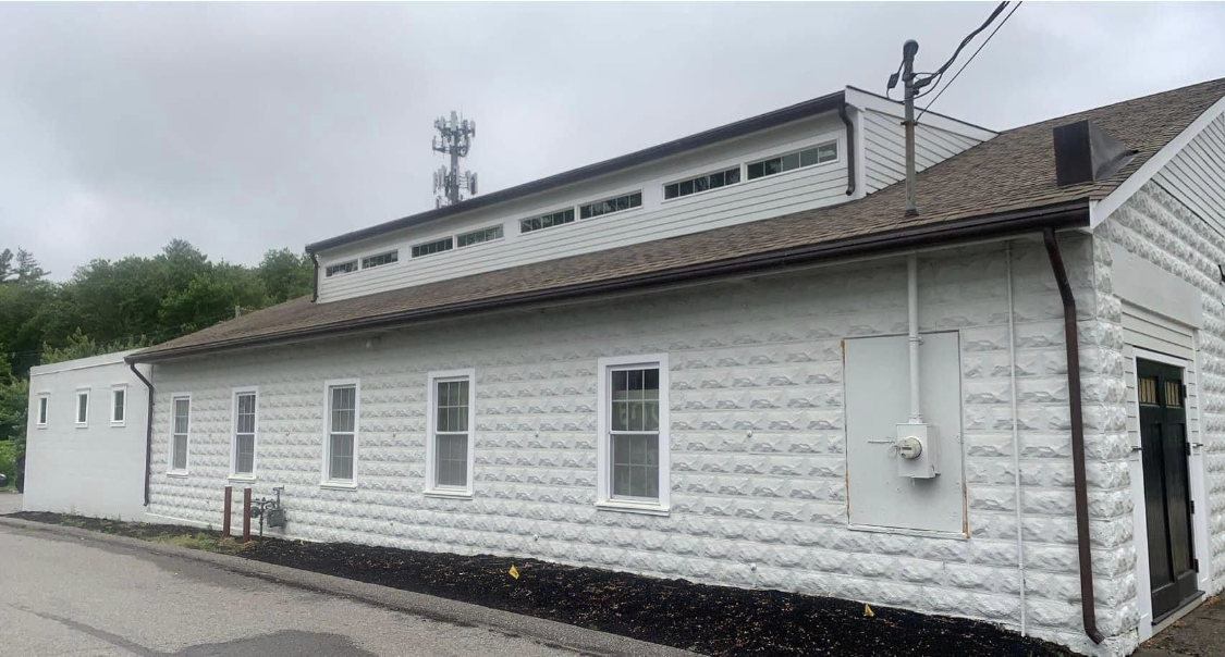 A white building exterior with full-coverage repaint painted by Brookstone Painting and Carpentry in Plymouth County and Cape Cod
